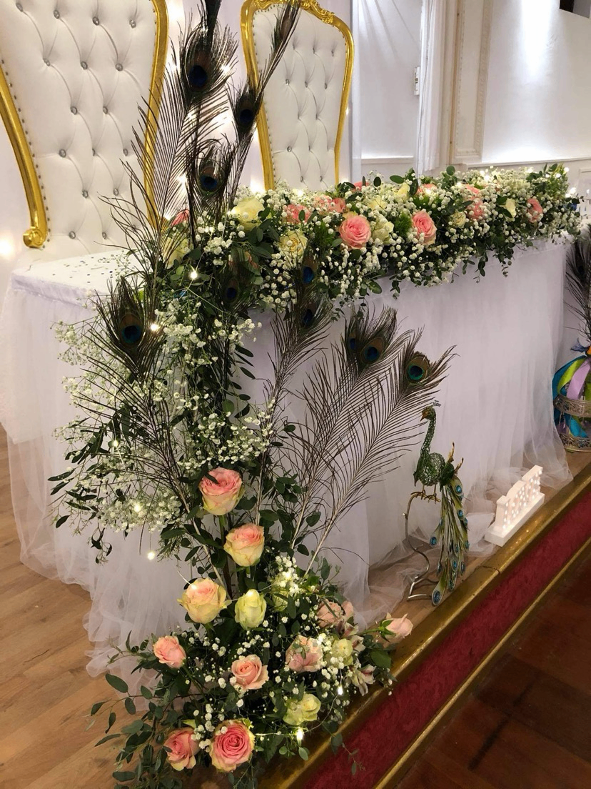 Table d’honneur com penas de pavão e rosas